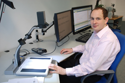 Foto Fachinformatiker am sehbehindertengemäß ausgestatteten Arbeitsplatz