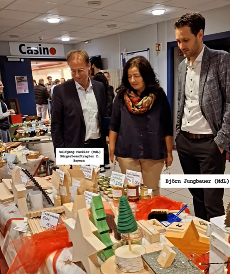 Teamleiterin Christine Haupt-Kreutzer mit Björn Jungbauer und Wolfgang Fackler an einem Stand des Basars